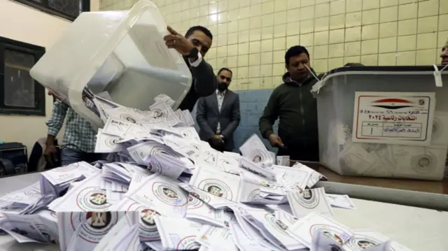 Egyptian electoral workers count ballots at the end of the last day of the Egyptian presidential elections in Cairo, Egypt, 12 December 2023.