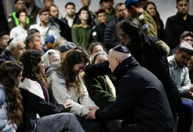 Israeli Defence Minister Yoav Gallant comforts the widow of Israeli military commander Lieutenant Colonel Tomer Grinberg