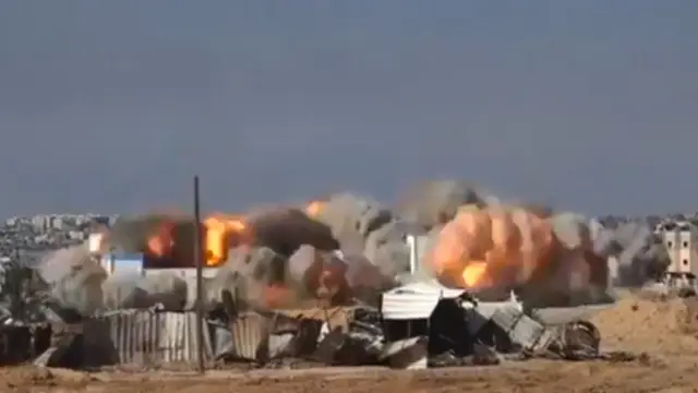 Screengrab of video showing explosions demolishing an UNRWA school in Beit Hanoun, in the northern Gaza Strip (12 December 2023)