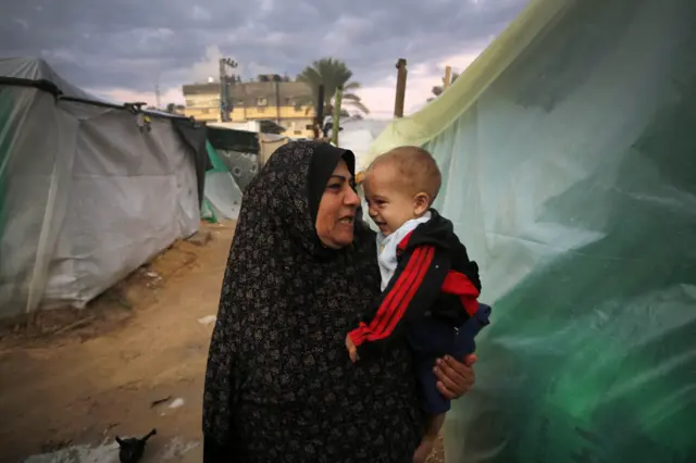 Palestinians struggle with cold weather as they stay in the makeshift tents they set up near Al Aqsa Martyrs Hospital in Deir al Balah, Gaza on December 14, 2023. (Photo by Ashraf Amra/Anadolu via Getty Images)