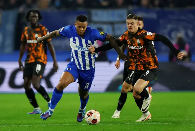 Brighton & Hove Albion's Igor Julio in action with Olympique de Marseille's Vitinha