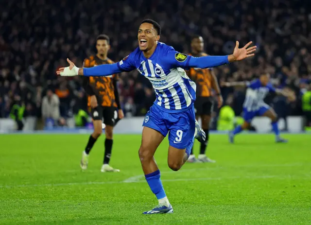 Joao Pedro celebrates with his arms wide open