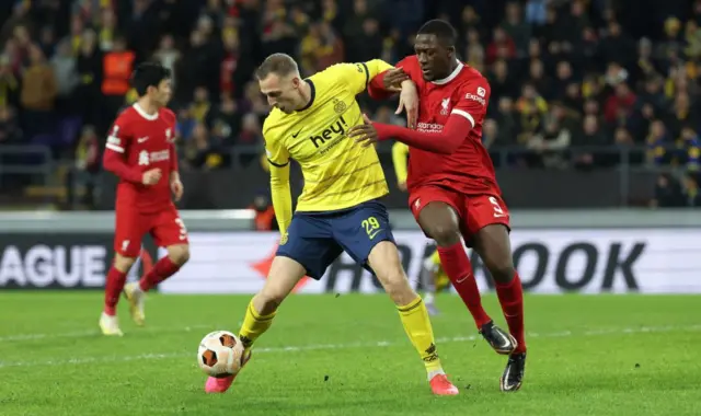 Union Saint-Gilloise's Gustaf Nilsson and Liverpool's Ibrahima Konate challenging for the balll