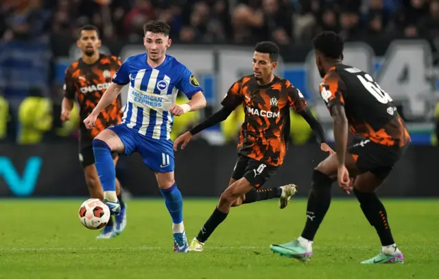 Billy Gilmour controls the ball under pressure from Marseille players