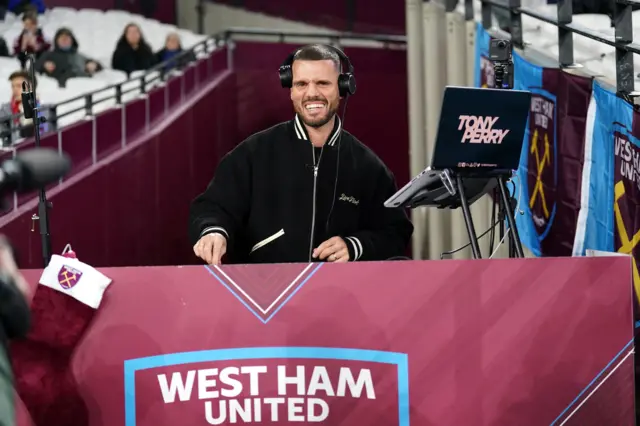 DJ Tony Perry plays music before kick-off at the West Ham Stadium