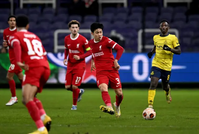 Wataru Endo of Liverpool passes the ball