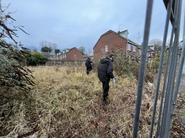 Police searching a wooded area