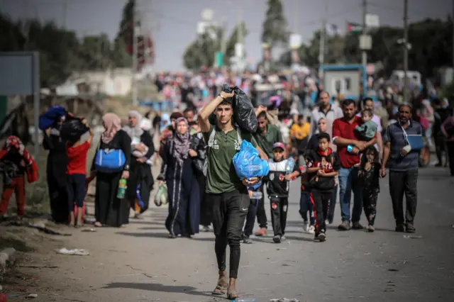 Palestinians leave their homes to escape Israel's bombardments as photographed on 11 November 2023