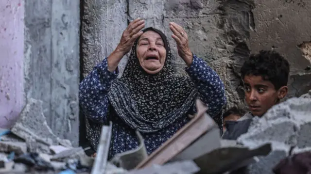 A Palestinian woman reacts following Israeli bombardment in Rafah, in the southern Gaza Strip on December 14, 2023, amid ongoing battles between Israel and the Palestinian militant group Hamas.