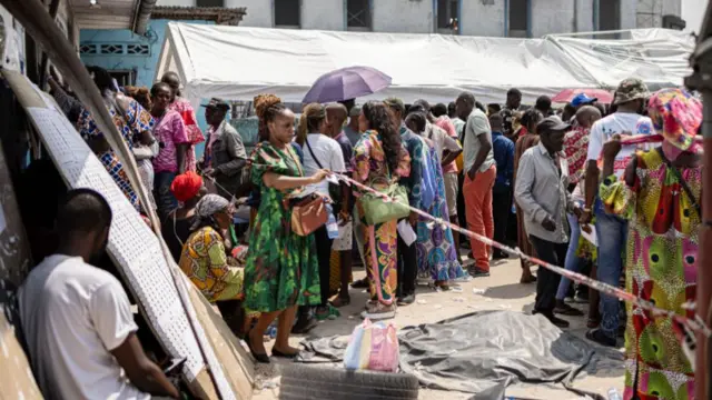 People queue for their voters cards at the Independent National Electoral Commission (CENI) offices in the neighbourhood of Kintambo, Kinshasa - 14 December 2023