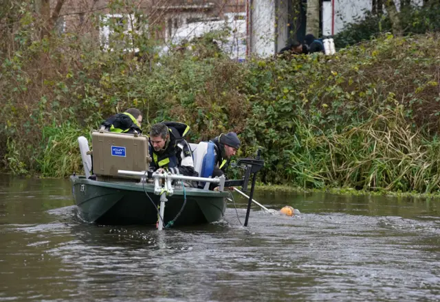 Orange buoy placed in water in River Wensum