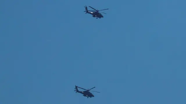 Israeli military helicopters fly over the Israel-Gaza border