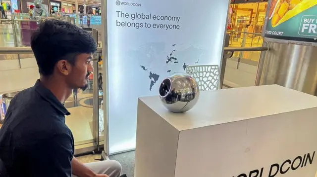 Kaleem, 22, an engineer in Bengaluru, signs up for WorldCoin by having his eyes scanned by the spherical device in Mantri Square Mall in Bengaluru, India July 25, 2023