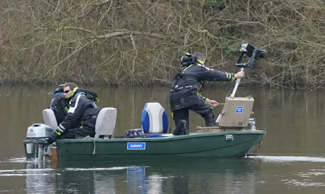 boat using extra equipment to hep with search.