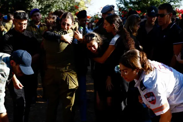 Mourners react as they attend the funeral of Israeli military Sergeant Oz Shmuel Aradi, who was killed in Gaza