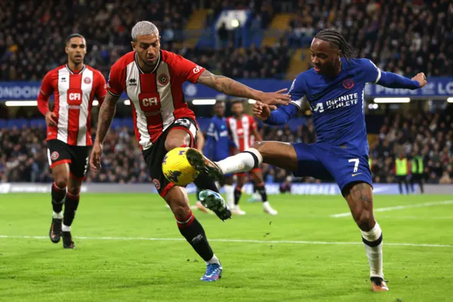 Vinicius Souza of Sheffield United battles for possession with Raheem Sterling of Chelsea