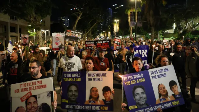 People hold signs as they protest following an announcement by Israel's military that they had mistakenly killed three Israeli hostages being held in Gaza by Palestinian Islamist group Hamas, at a demonstration in Tel Aviv, Israel