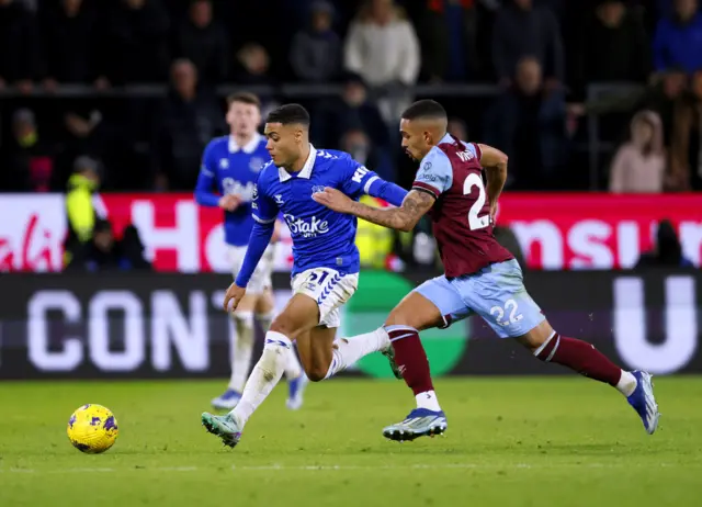 Everton's Lewis Dobbin and Burnley's Vitinho battle for the ball