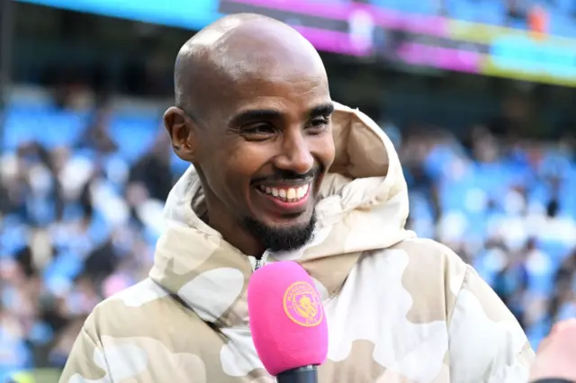 Mo Farah speaking to media at Manchester City