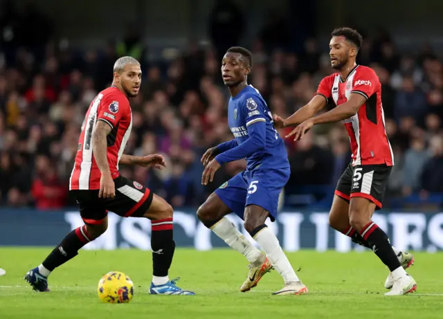 Sheffield United's Vini Souza and Auston Trusty in action with Chelsea's Nicolas Jackson