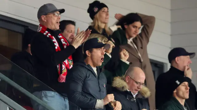 Wrexham co-owner Ryan Reynolds celebrates a goal in the stands