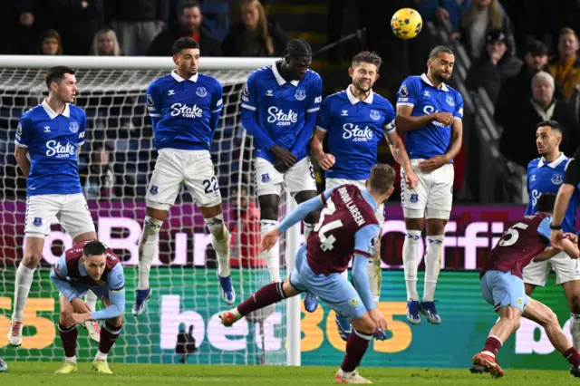 Everton's English defender James Tarkowski heads the ball away at a freekick taken by Burnley's Danish striker Jacob Bruun Larsen