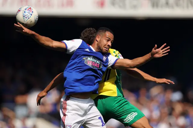 Jordan Graham of Ipswich Town challenges for the ball against a Norwich player