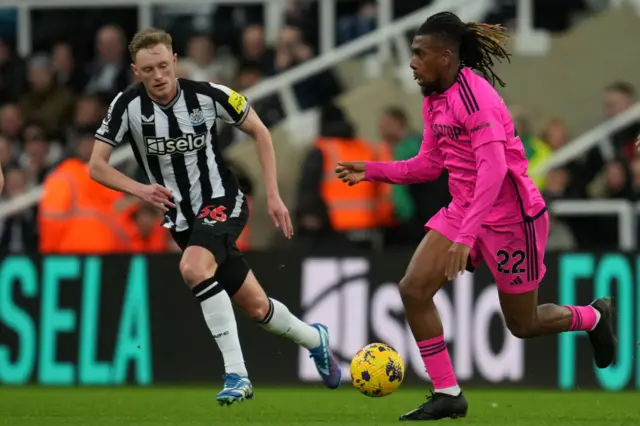 Alex Iwobi vies with Newcastle United's English midfielder Sean Longstaff