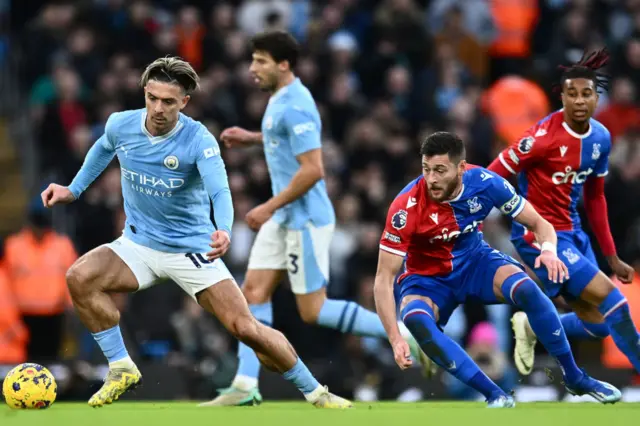 Jack Grealish of Manchester City and Joel Ward of Crystal Palace