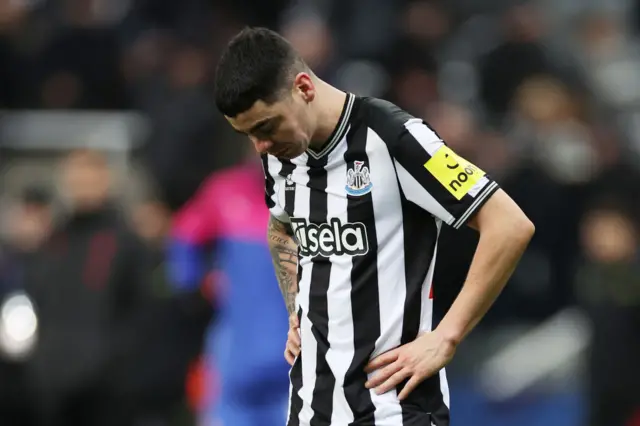 Miguel Almiron looks down at the ground with his hands on his hips in disappointment