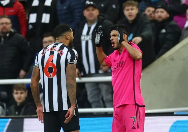 Newcastle United's Jamaal Lascelles clashes with Fulham's Raul Jimenez