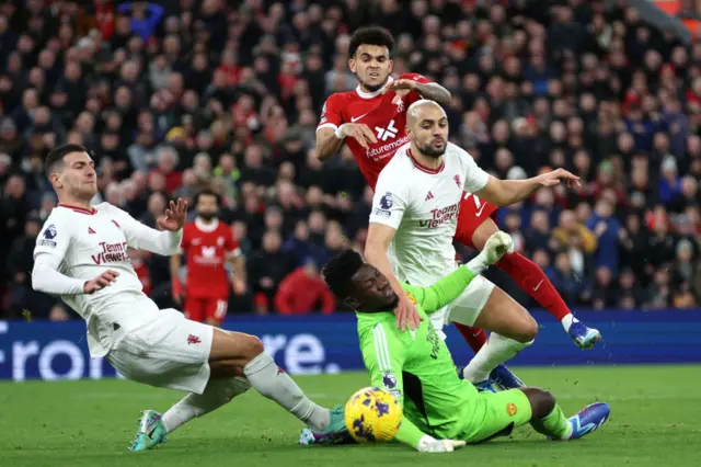 Luis Diaz of Liverpool has a shot blocked by Sofyan Amrabat and Andre Onana