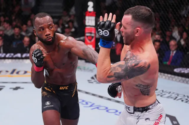 Leon Edwards punches Colby Covington