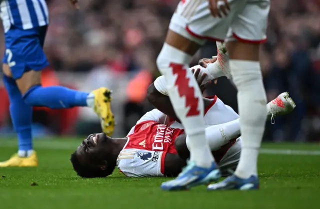 Arsenal's Bukayo Saka reacts after sustaining an injury