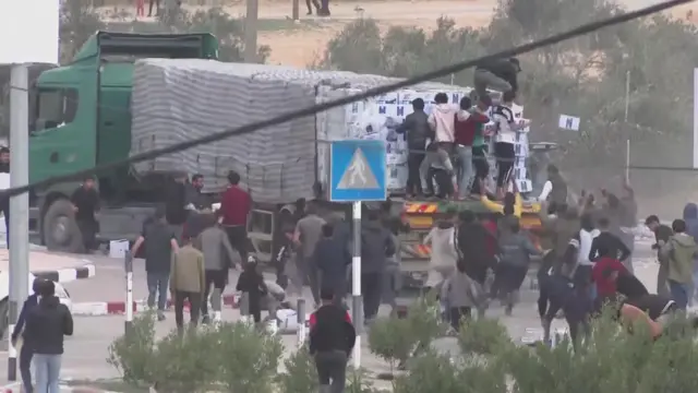 Boxes of aid being thrown off an aid lorry in Gaza