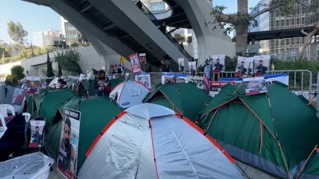 Tents lined up with photos of hostages on