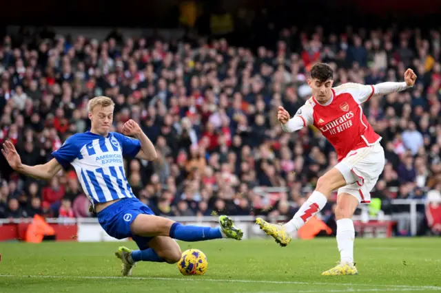 Kai Havertz of Arsenal shoots past Jan Paul van Hecke of Brighton & Hove Albion