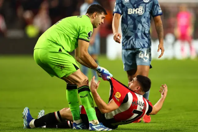 Emiliano Martinez drags Brentford's French striker Neal Maupay