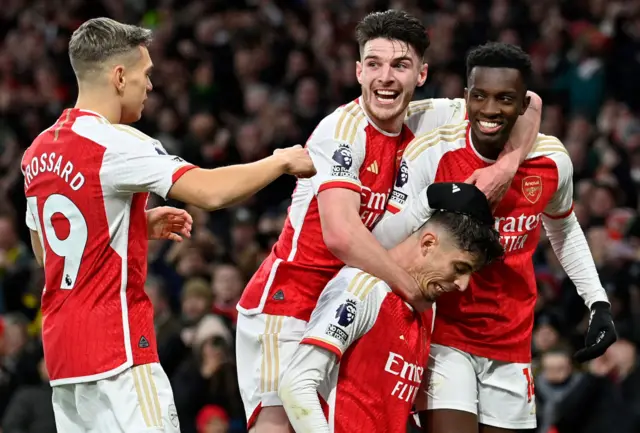 Kai Havertz is mobbed by teammates Arsenal's Belgian midfielder Leandro Trossard, Arsenal's English midfielder Declan Rice and Arsenal's English striker Eddie Nketiah