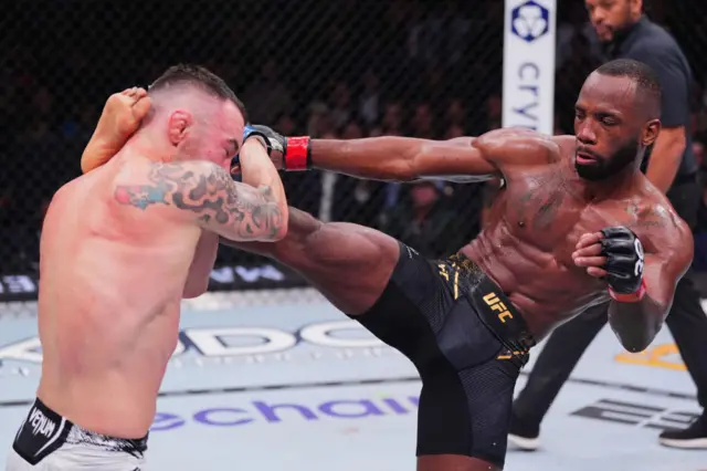 Leon Edwards kicks Colby Covington in the head