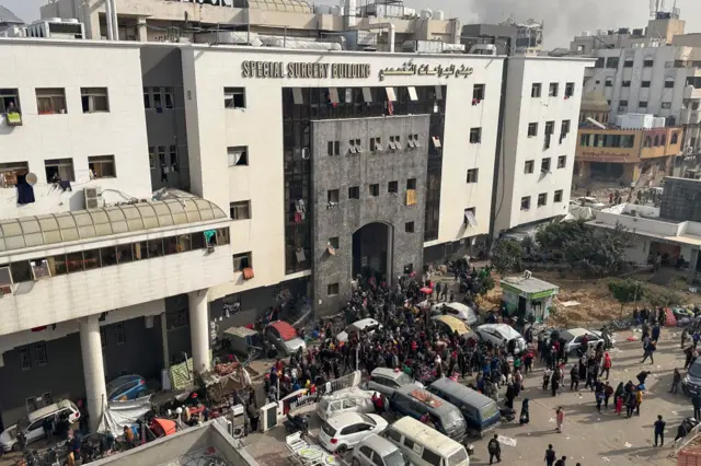 Displaced Palestinians gather in the yard of Gaza's Al-Shifa hospital