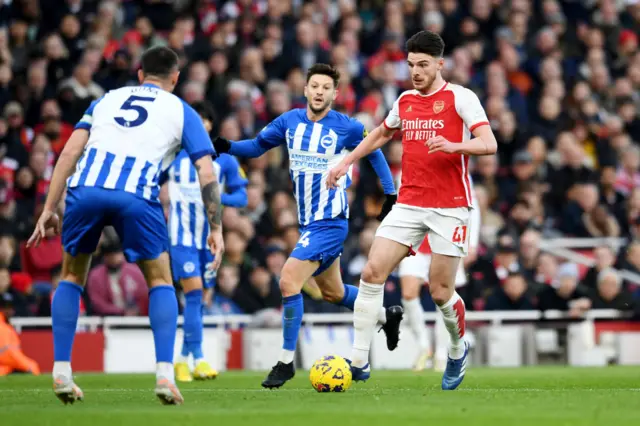 Declan Rice of Arsenal runs with the ball from Adam Lallana of Brighton & Hove Albion