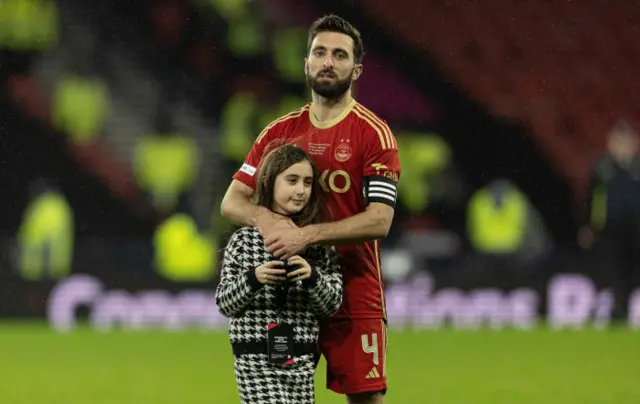 Aberdeen captain Graeme Shinnie is joined by his daughter at full-time