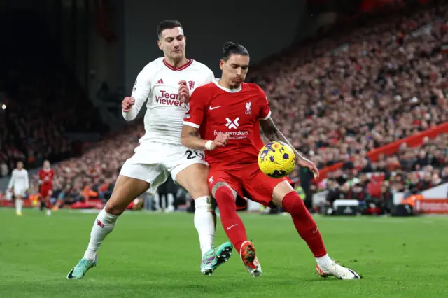 Diogo Dalot of Manchester United battles for possession with Darwin Nunez of Liverpool