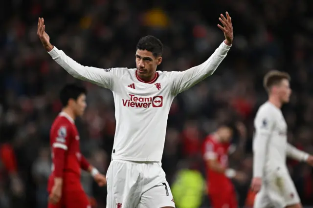 Raphael Varane rallies the fans at the end of the first half