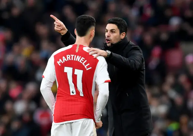 Mikel Arteta speaks to Gabriel Martinelli of Arsenal during the Premier League match between Arsenal FC and Brighton & Hove Albion