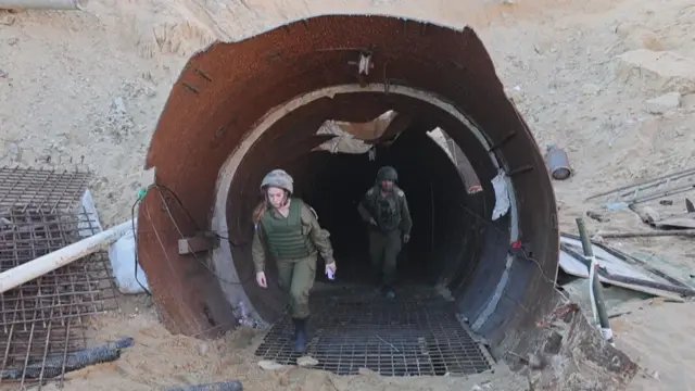 The entrance of the tunnel showing two people walking out