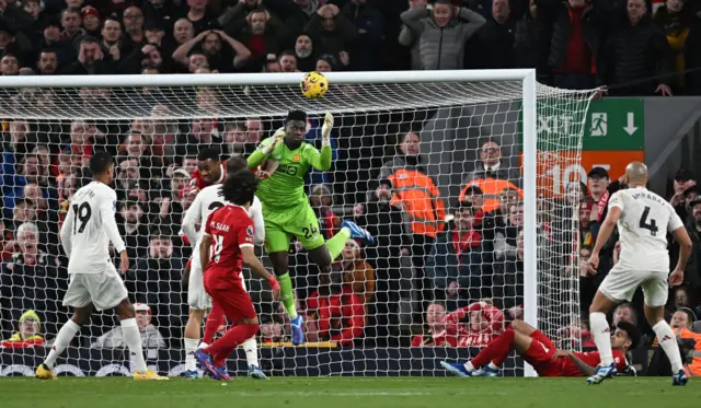 Andre Onana saves from the path of Liverpool's Egyptian striker Mohamed Salah