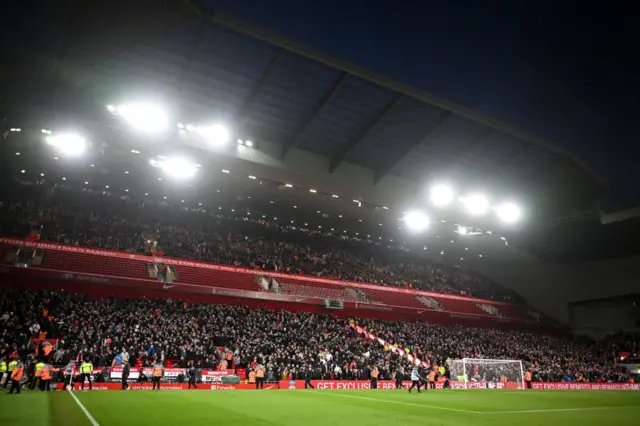 Fans take their seats in the new tiers of the Anfield road Stand