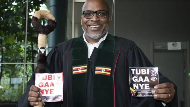 Pastor Martin Ssempa, an activist in favor of the Anti-Homosexuality Bill, displays stickers bearing the message 'Tubigaanye' (we have refused) after a session at the Constitutional Court in Kampala, Uganda, 18 December 2023